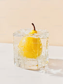 Yellow pear encapsulated in clear ice cube