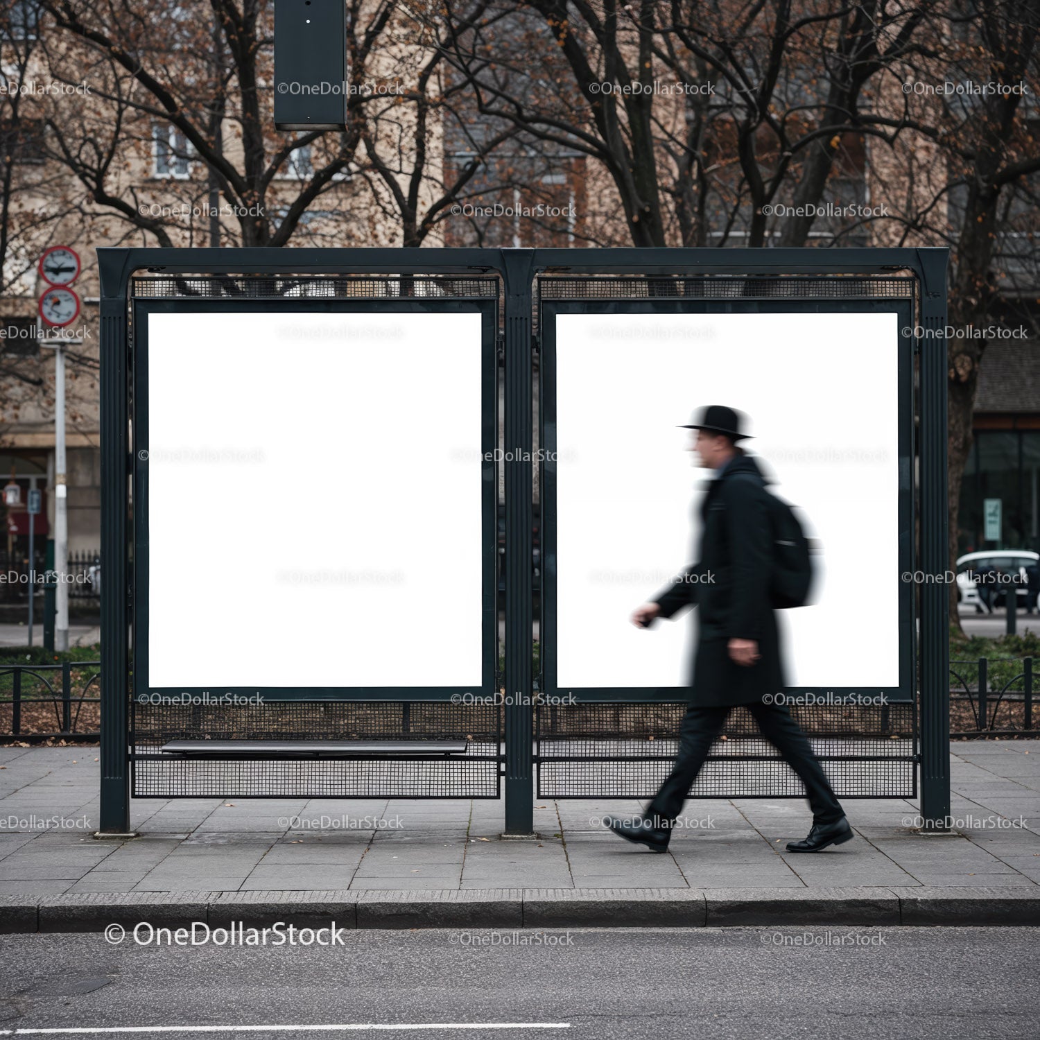 Man walking past empty urban bus stop billboards