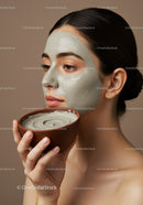 Young Woman with Grey Clay Facial Mask Applying Skincare Ritual for Beauty