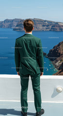 Man in Green Suit Overlooking Blue Sea and Rocky Cliffs