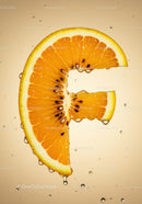 Fresh orange slice shaped like the letter F with droplets