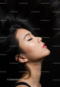 Profile of calm woman with long black hair and pink lips