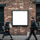 Blank billboard on urban brick wall with pedestrians