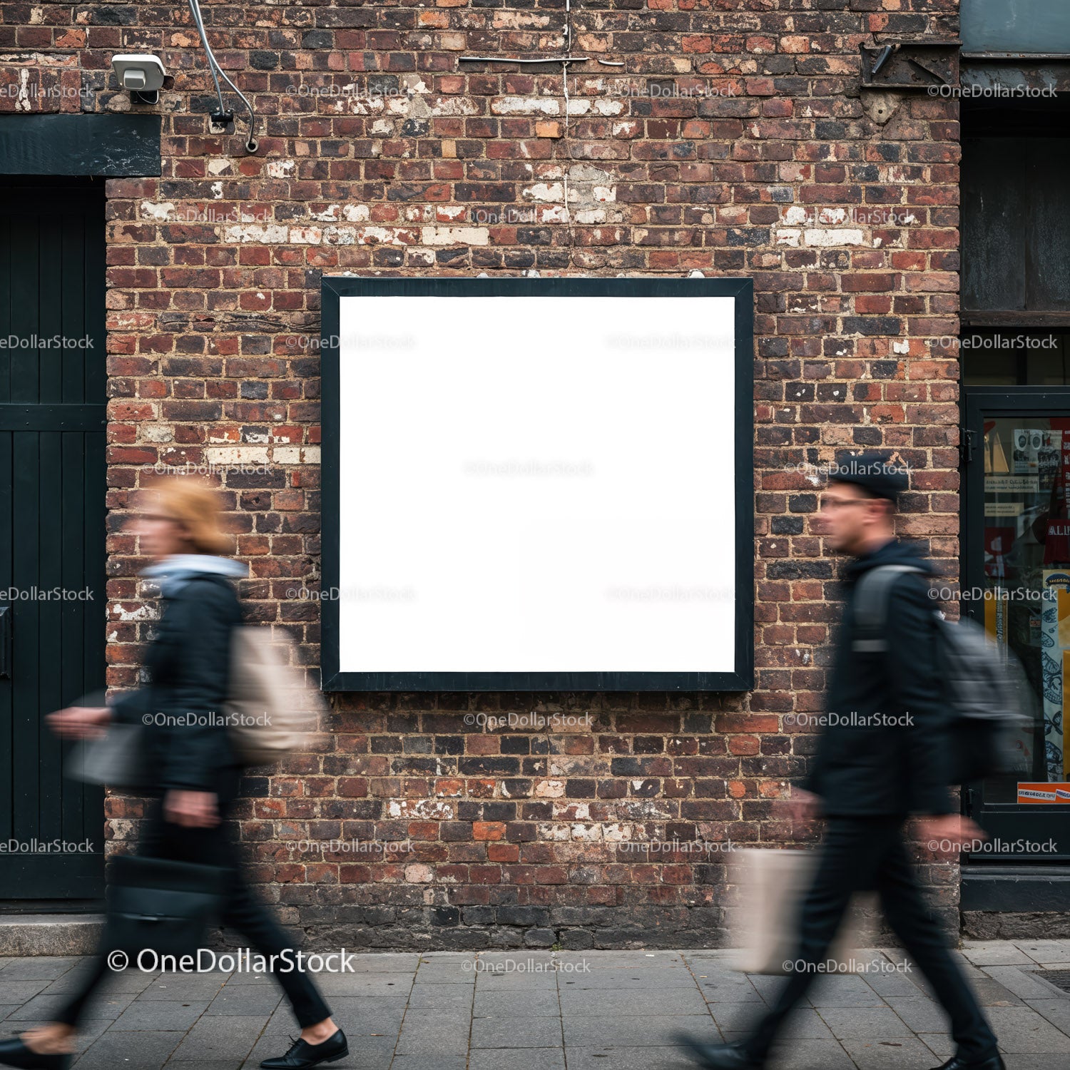Blank billboard on urban brick wall with pedestrians