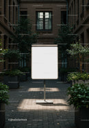 Blank white board in urban courtyard with plants