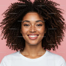 Bright Smile of Woman with Curly Hair Against Pink Background