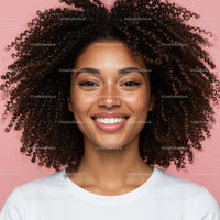 Bright Smile of Woman with Curly Hair Against Pink Background