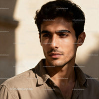 Thoughtful young man in warm natural sunlight