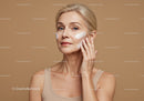 Elegant Mature Woman Applying Skin Cream for Youthful Aging