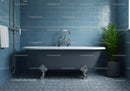 Classic clawfoot bathtub in elegant blue tiled bathroom