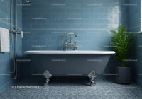 Classic clawfoot bathtub in elegant blue tiled bathroom