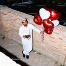 Man Holding Heart Balloons and Chocolates Outdoors