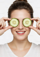 Smiling Woman with Cucumber Slices Over Eyes for Fresh Skincare