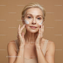Elegant Mature Woman Applying Facial Moisturizer for Youthful Skin