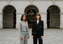 Stylish Businesswomen Standing in Front of City Building