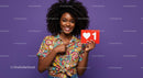 Bright Smiling Woman Holding Red Social Media Like Icon in Colorful Outfit
