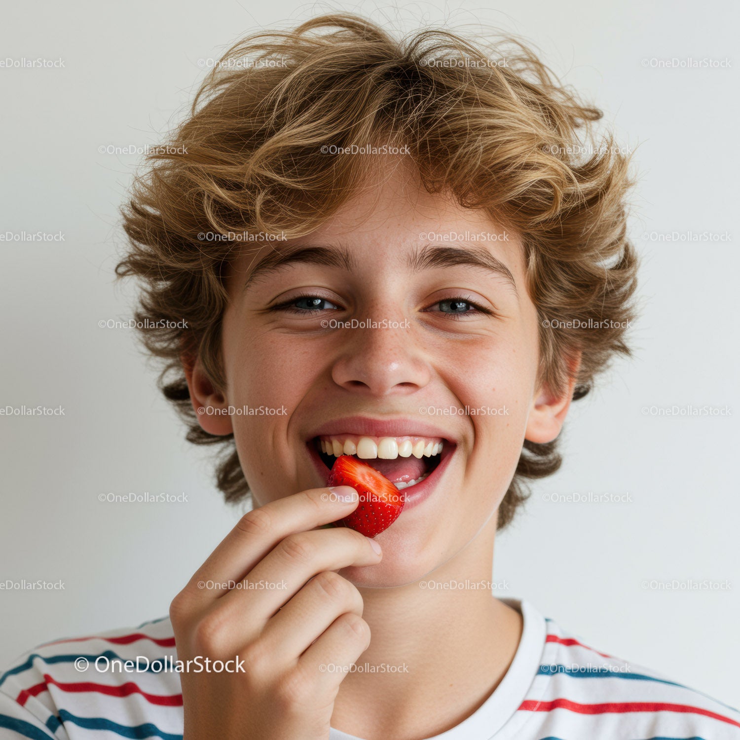 Teenage Boy Smiling and Eating Strawberry in Casual Summer Scene