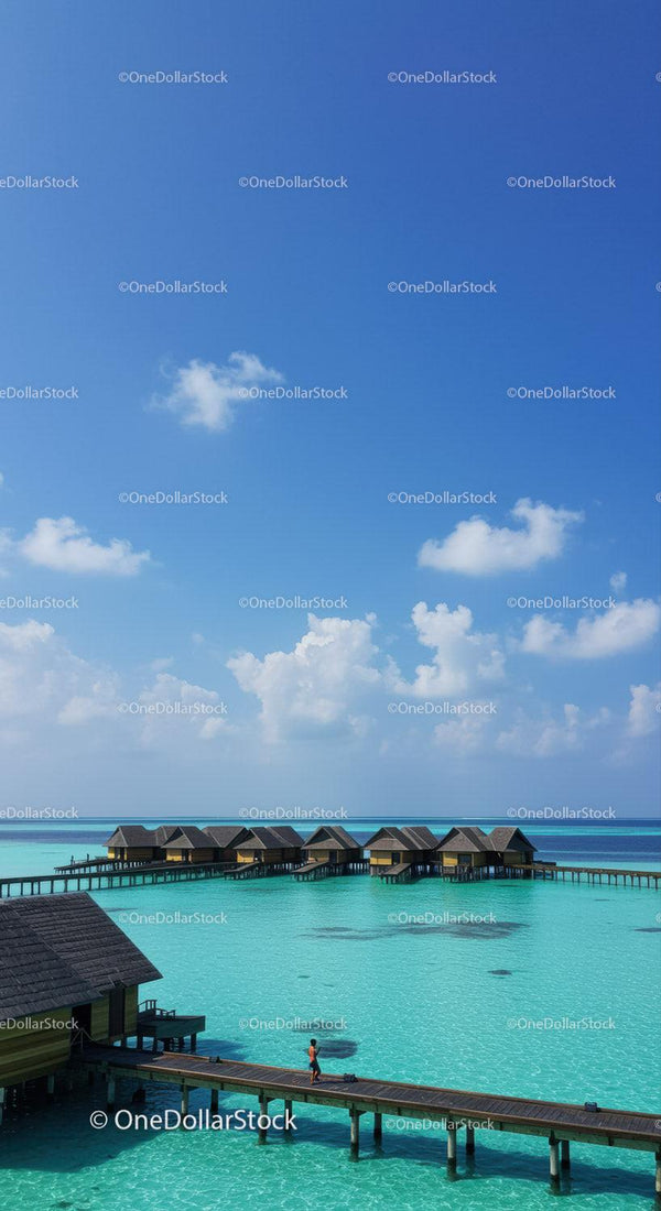 Beautiful Overwater Bungalows with Clear Turquoise Water and Blue Sky