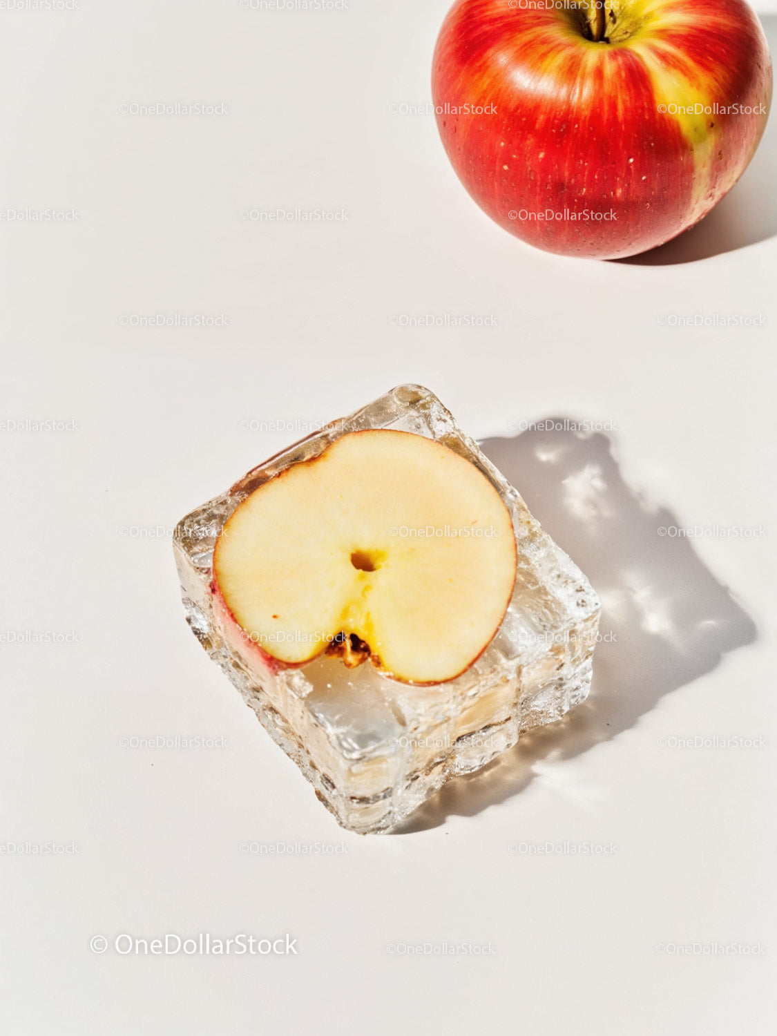 Fresh apple slice frozen in clear ice cube on white surface