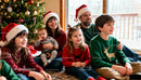 Family enjoying cozy Christmas moments by the tree