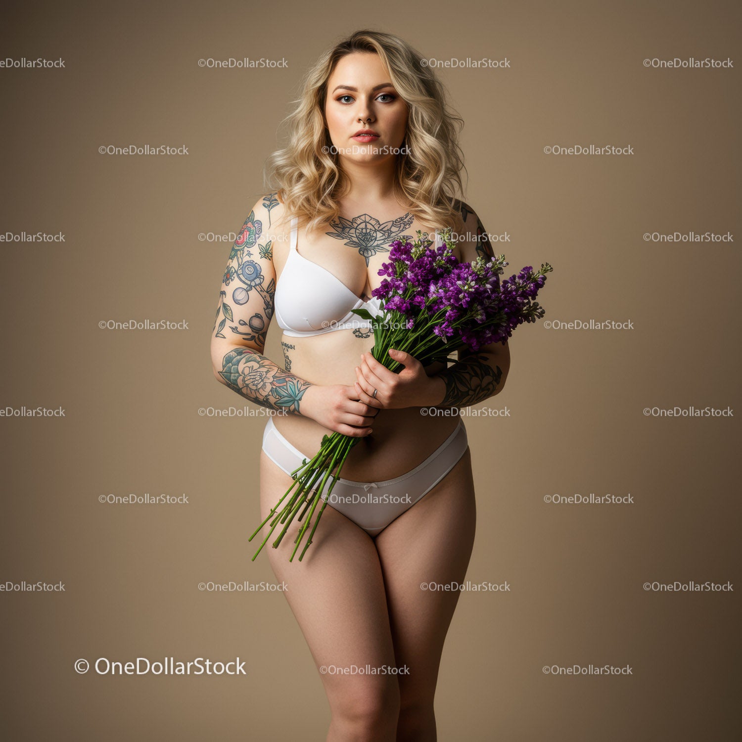 Elegant Woman with Tattoos Holding Purple Flowers in Studio