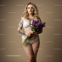 Elegant Woman with Tattoos Holding Purple Flowers in Studio