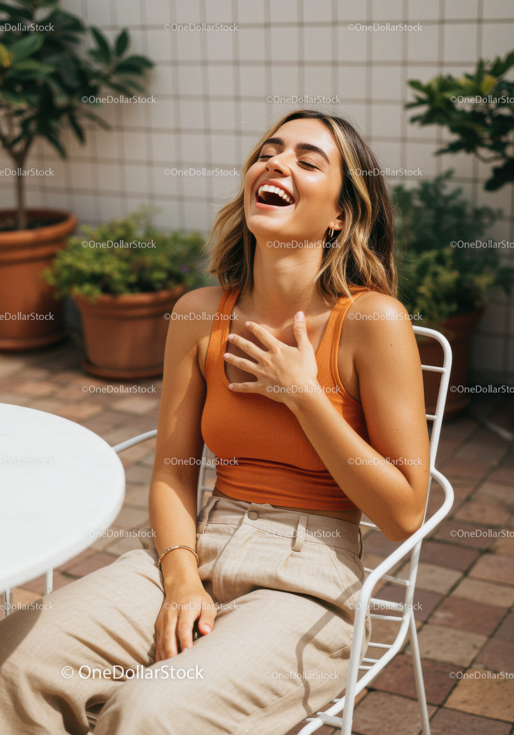 Joyful Woman Laughing Outdoors on a Sunny Terrace in Casual Fashion