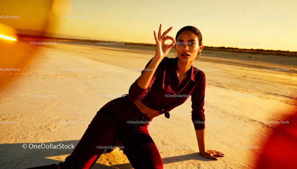 Young woman expressing OK gesture in warm desert light