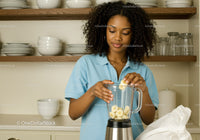 Young Woman Preparing Banana Smoothie in Modern Kitchen