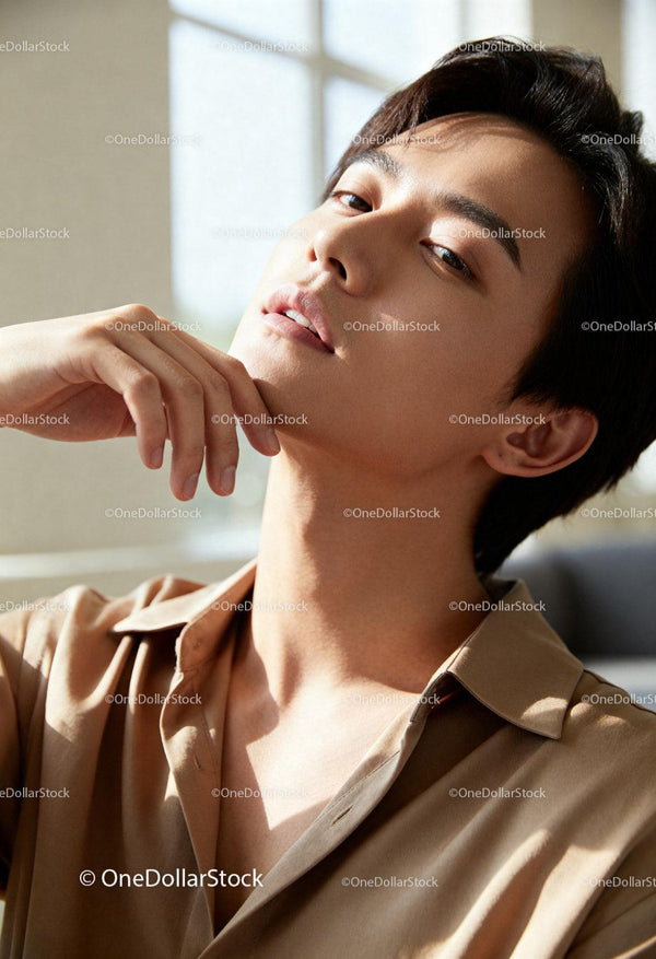 Calm young man enjoying sunlight with relaxed pose