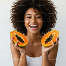 Young Woman Holding Halved Papayas with Lush Orange Interior and Black Seeds
