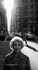 Elderly Woman in Busy City Street Surrounded by Vintage Cars