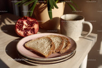 Fresh Sliced Bread with Pomegranate and Coffee Mug on Wooden Table