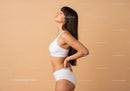 Serene Woman in White Sportswear Posing in Minimalist Studio