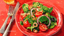 Fresh Vegetable Salad with Cherry Tomatoes and Spinach in Red Bowl