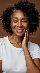 Confident Smiling African American Woman with Curly Hair in Studio