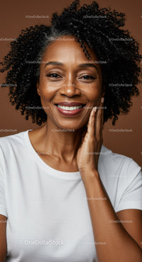 Confident Smiling African American Woman with Curly Hair in Studio