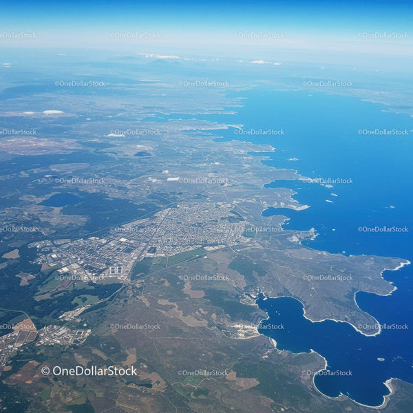 Scenic Aerial View of Coastal City with Lakes and Green Spaces