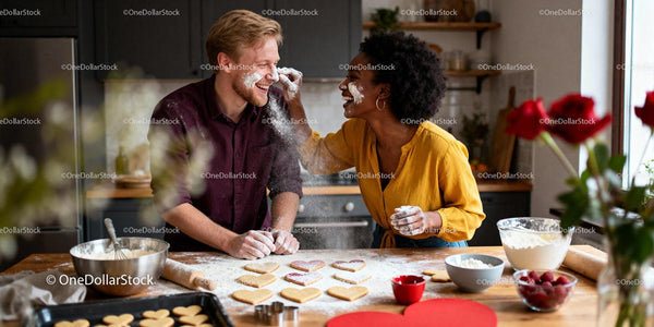 Couple Playfully Baking Heart-Shaped Cookies Together
