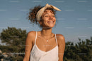 Portrait of Joyful Woman with Curly Hair and Headscarf in Sun