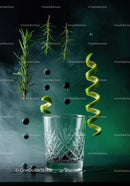 Fresh herbs and citrus peels suspended over glass