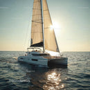 Luxury Sailing Yacht with Beige Sails on Calm Ocean at Sunset