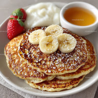 Stack of Fluffy Pancakes with Banana Slices Strawberries and Honey