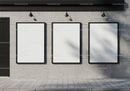 Three blank posters on modern concrete wall