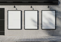 Three blank posters on modern concrete wall