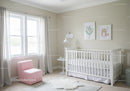 Bright Modern Nursery with White Crib Pink Armchair and Wall Art