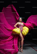 Fashion Model in Vibrant Pink and Yellow Flowing Gown