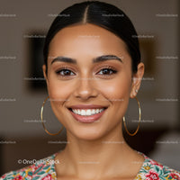 Close-Up Portrait of a Smiling Woman with Elegant Earrings and Flawless Skin