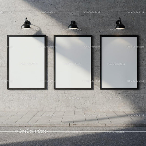 Three blank vertical posters on concrete wall under lights JPG Mockup Image