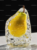 Fresh yellow pear preserved in crystal clear ice block